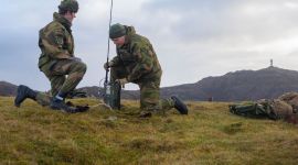 To soldater med en radio ute i felt.